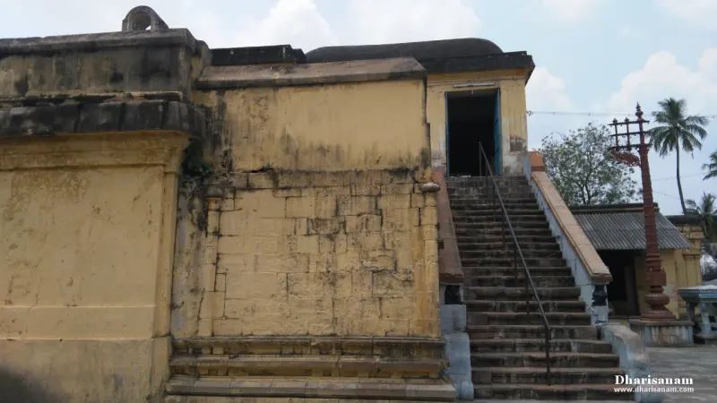 Long stone stairway climbing the yellow wall of the elevated shrine