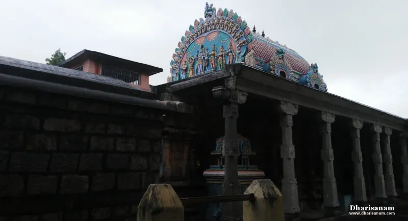 Painted dome with figures over a stone wall and a long corridor of stone pillars