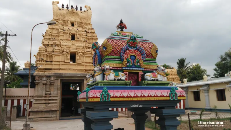 A colourful mandapam roof with bull figures, with the Rajagopuram rising behind it