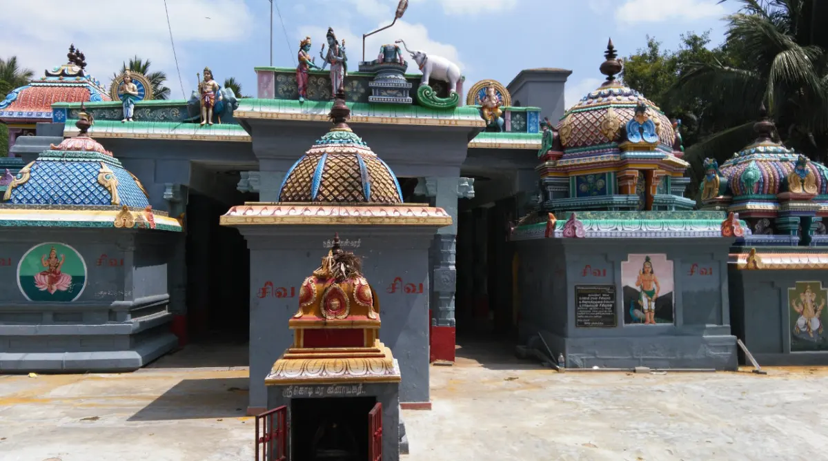 Painted shrine domes and flat-roofed shrines around the courtyard; a small shrine front stands in the foreground