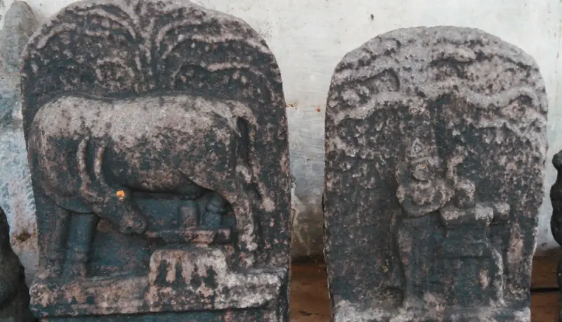 Two slabs carved with a cow over a lingam and a worshipper