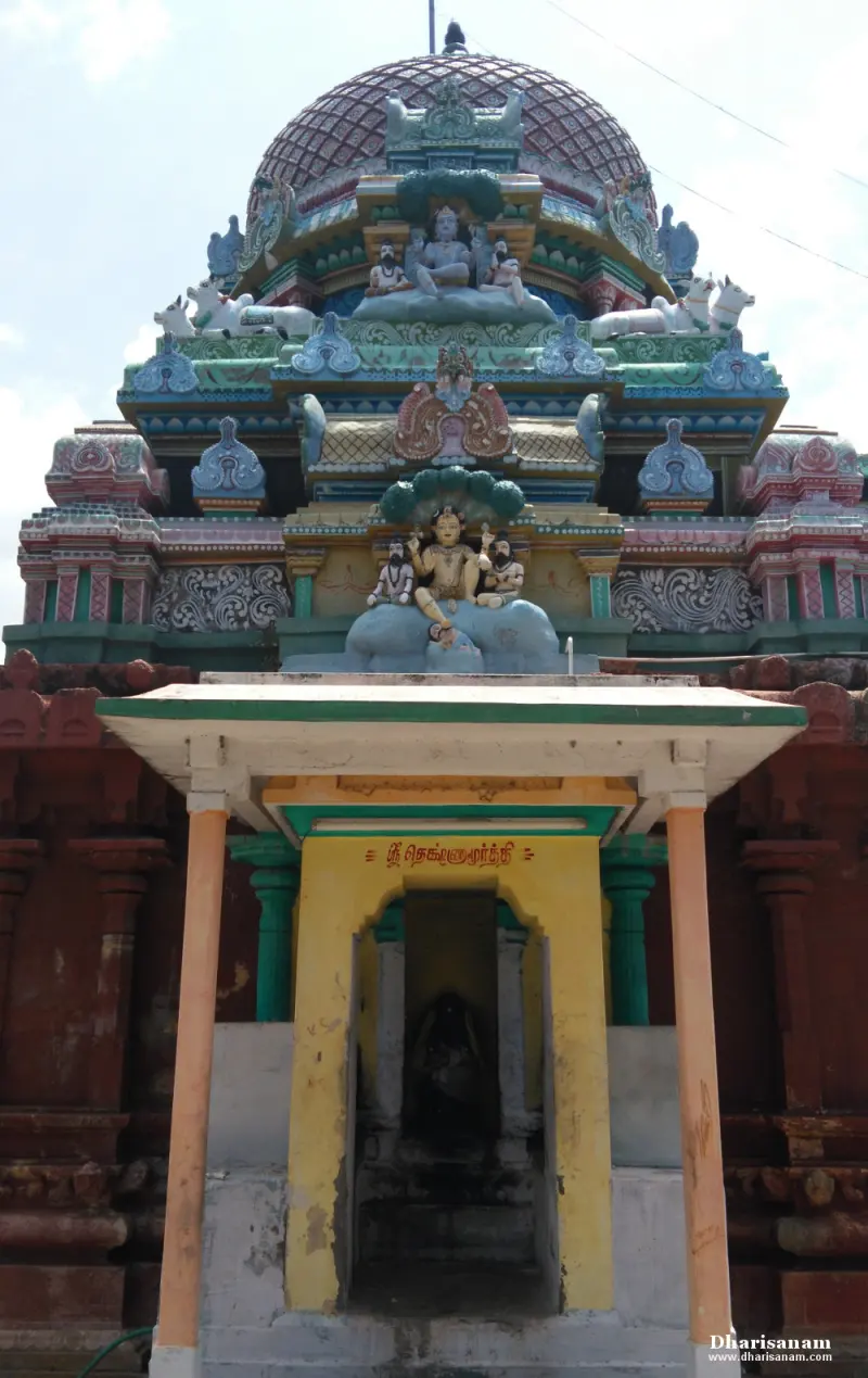 A small yellow shrine under the tower, its lintel inscribed in Tamil as Sri Dakshinamurthy