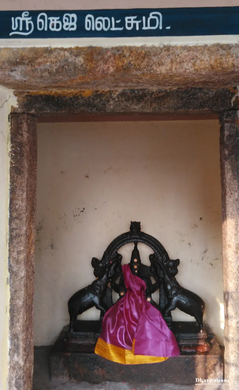Goddess idol in pink silk flanked by two elephants in a shrine