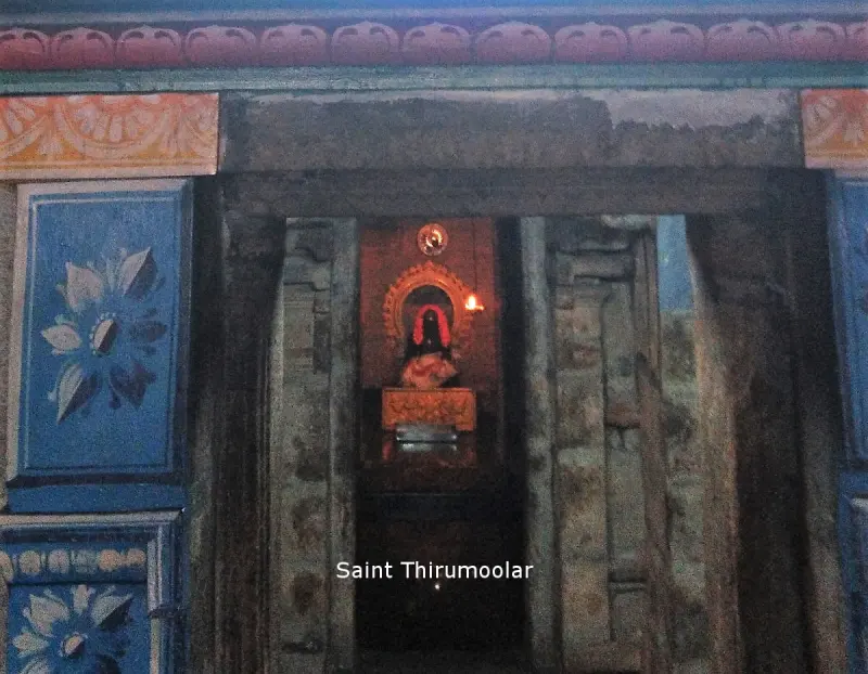 A painted wooden doorway with a lit shrine inside, and the words Saint Thirumoolar on the image
