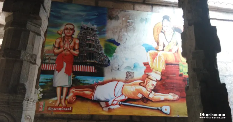 A wall painting of a saint bowing at the feet of a seated figure, and a standing saint with folded hands