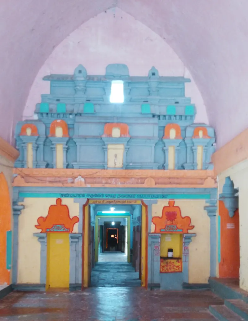 An interior passage with a blue stepped tower above the doorway