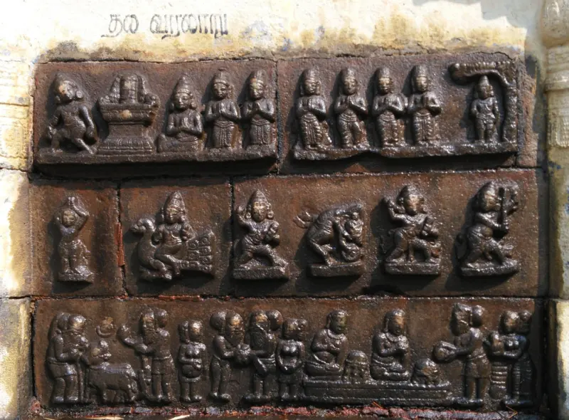 Three rows of stone relief panels with seated and standing figures, one carrying a bull.