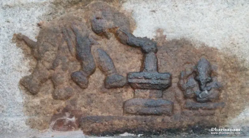 A weathered wall relief of an elephant at a lingam, with a small Vinayakar figure at the right