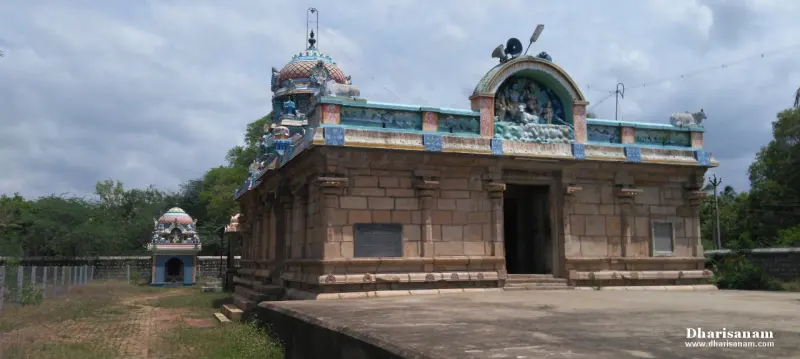 Stone shrine with a painted roof on a wide stone platform, with a small shrine in the distance on the left