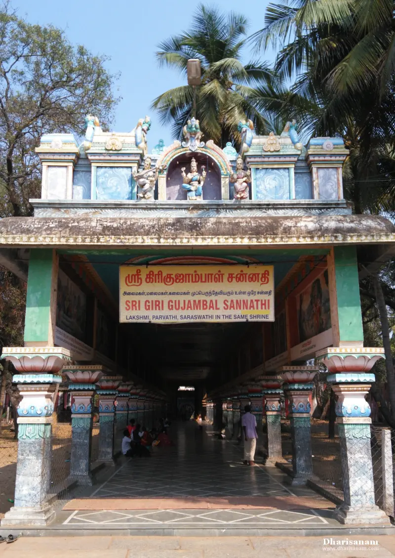 A pillared corridor leading to a shrine, with a sign naming the Goddess and sculptures on its roof