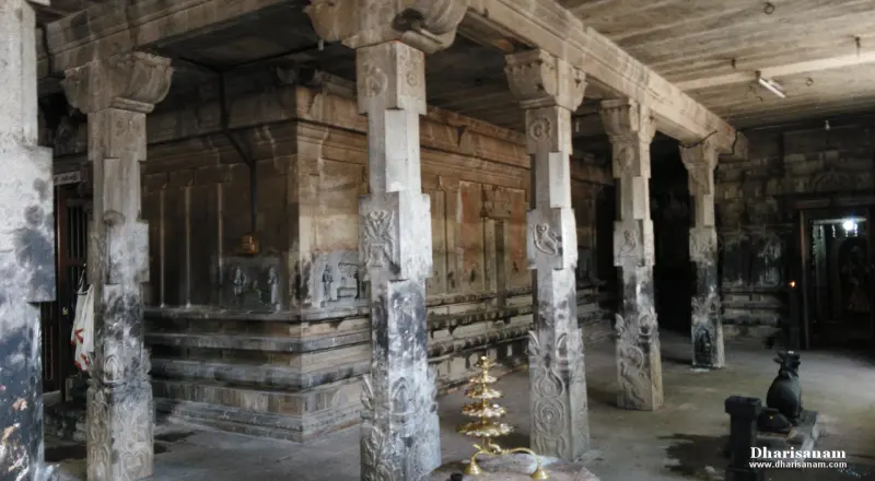 Hall of carved stone pillars with a lamp stand and a Nandi at the right