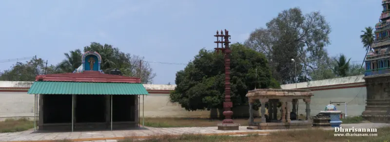 Open courtyard with tall flagstaff, pillared hall and shrine buildings