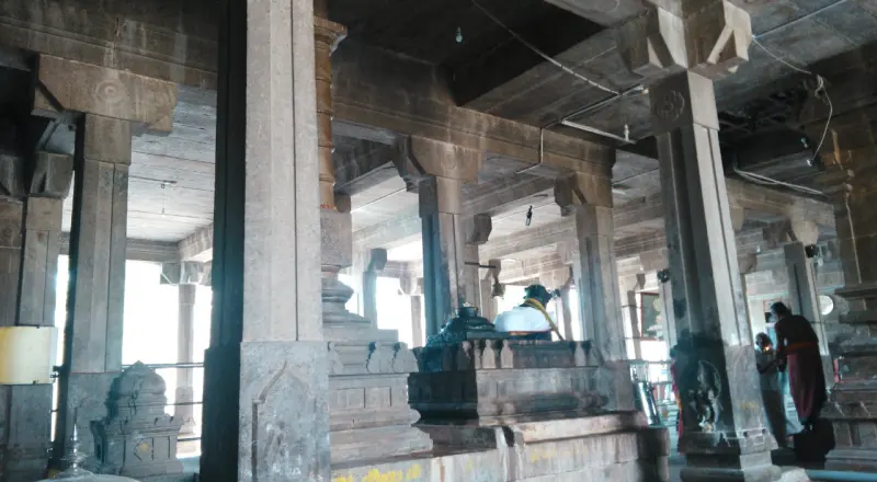 Stone pillars and shrines inside the dim hall