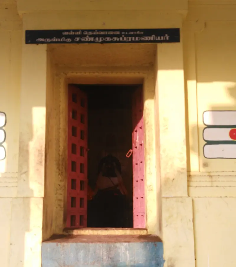 Red grille doors under a Shanmuga Subramaniyar name board