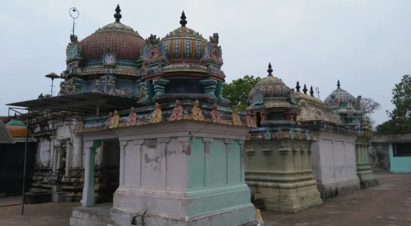 Several domed shrine roofs of different sizes, with colourful carvings, in the temple.