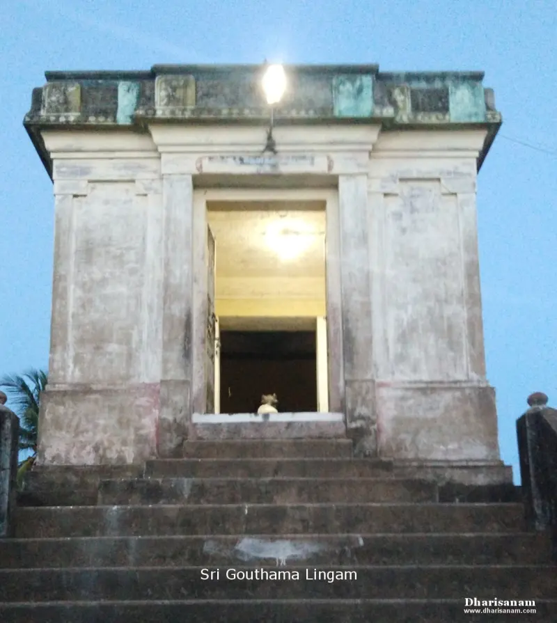 A small stone shrine with an open doorway sits at the top of a flight of wide steps, with a lamp lit above