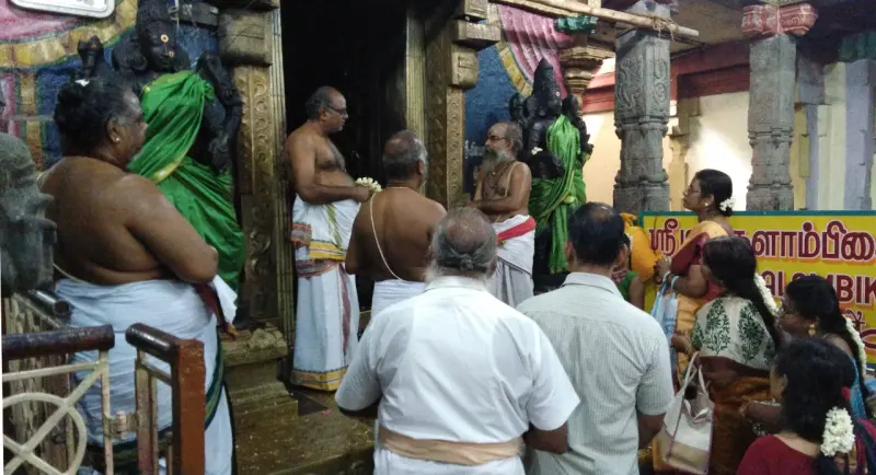 Priests and devotees before the goddess shrine doorway