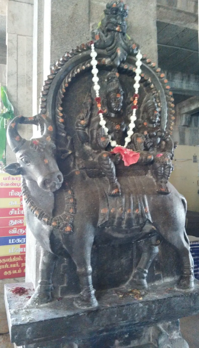 Dark stone relief of the divine couple seated on Nandi