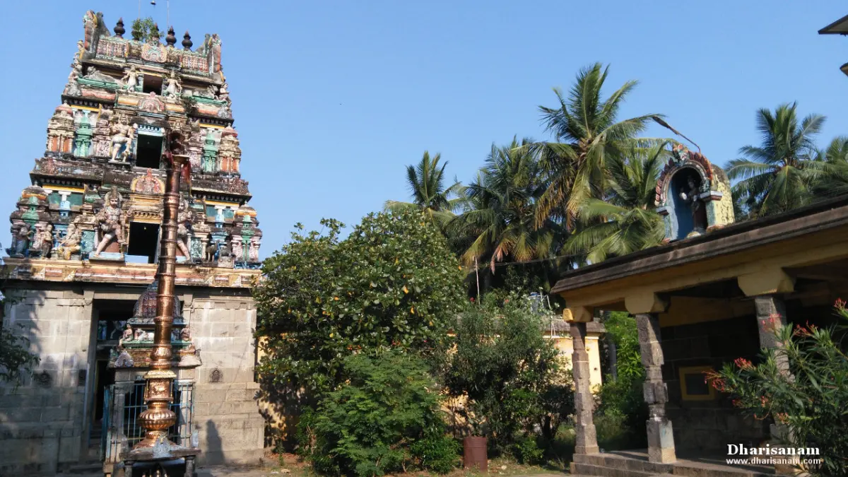 A sculptured tower with a tall flagstaff before it