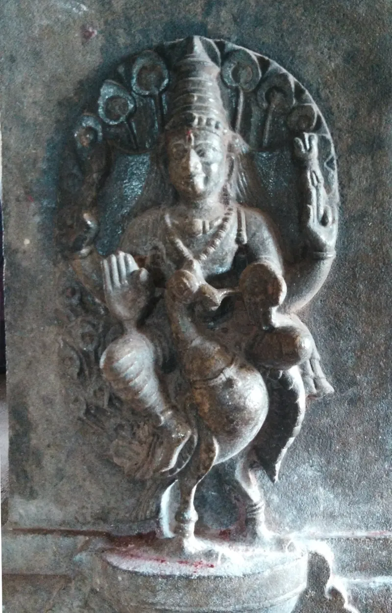 Stone relief of Murugan seated on a peacock