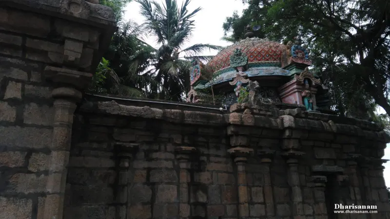 Colourful sculpted dome rising behind weathered stone walls