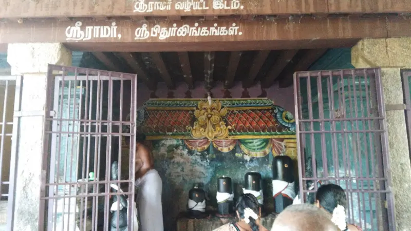 Four black lingams with white cloth in an iron-grilled shrine under a Tamil sign naming Lord Ram and the Pithur lingams.
