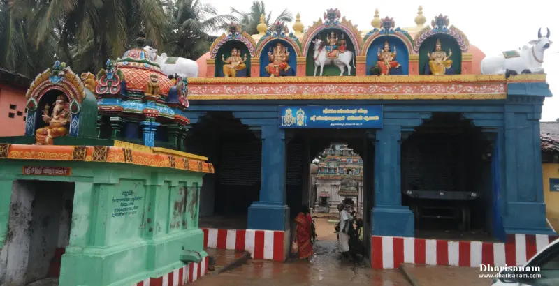 Blue entrance porch with painted deity figures and white bulls above, devotees walking in