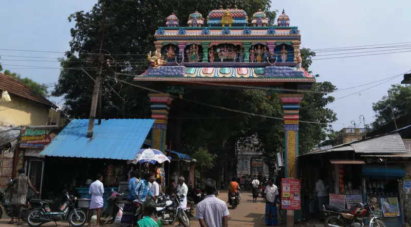 Colourful deity arch over a busy market street