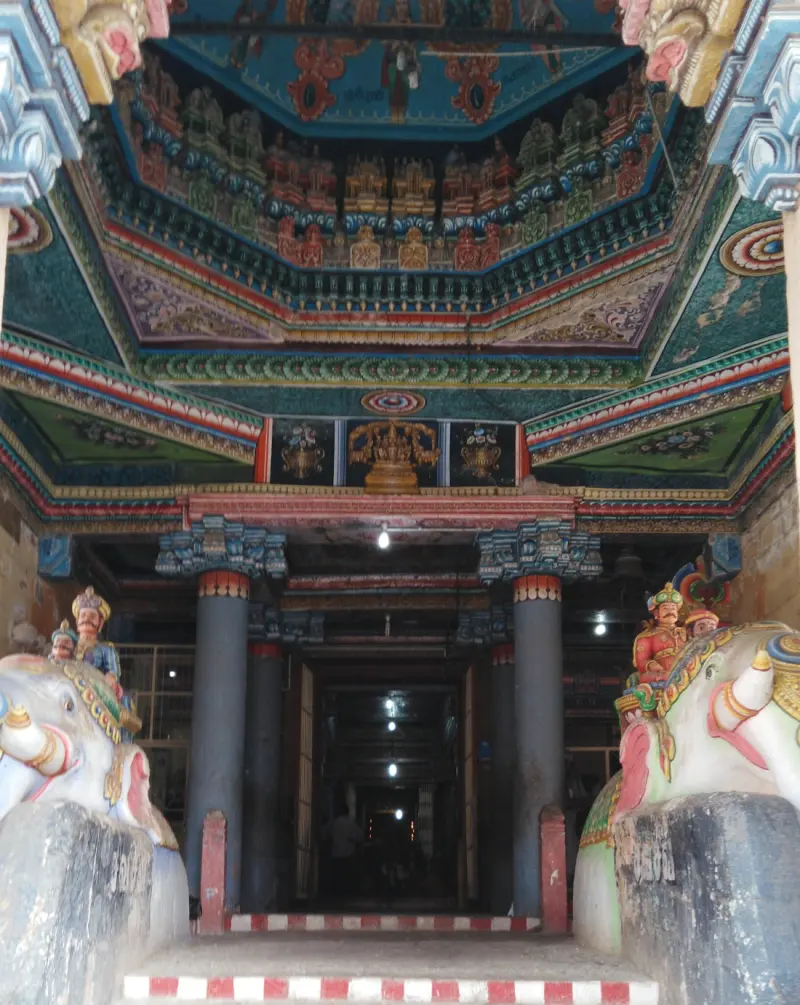 Pillared hall entry with colourful ceiling and flanking elephants