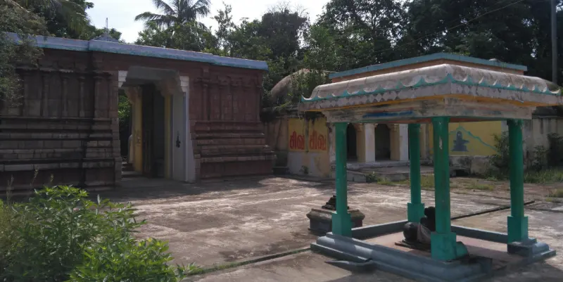 An open courtyard with a pillared Nandi shelter and shrines