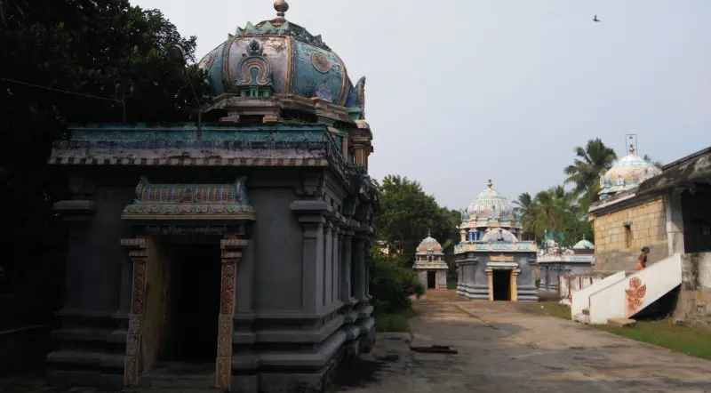 A row of small shrines with domed towers along a path