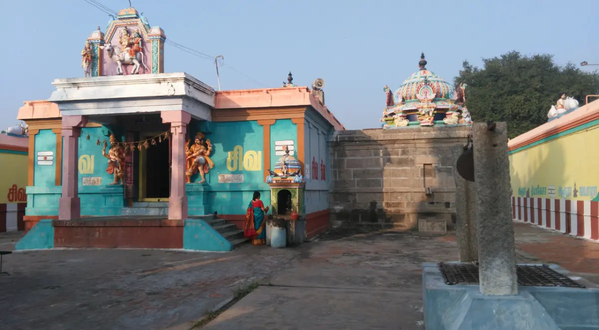 A blue-green shrine with Shiva-Parvati on Nandi above the doorway