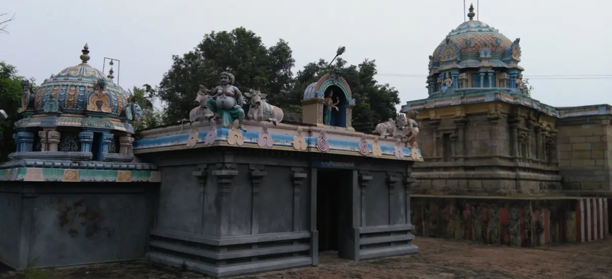 Two domed shrine towers with carved figures on the parapet