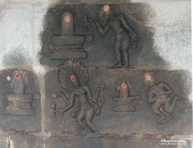 A stone relief panel showing lingams, a figure holding a lamp, a standing figure and a kneeling figure