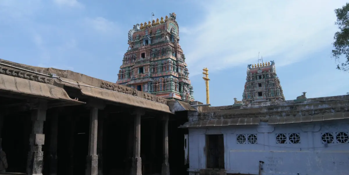 Two colourful towers rising above stone pillared halls