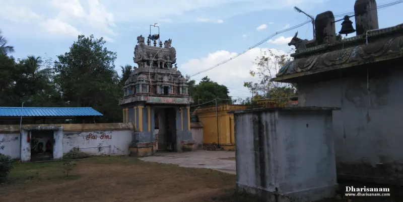 The gateway tower in the distance, with a stone Nandi and a bell on a roof at right.