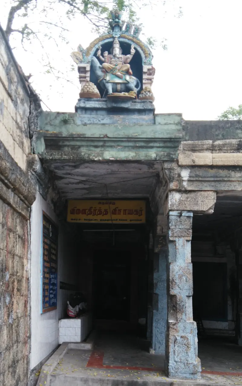 Entrance with a name board and a painted Vinayakar figure seated on a mouse above