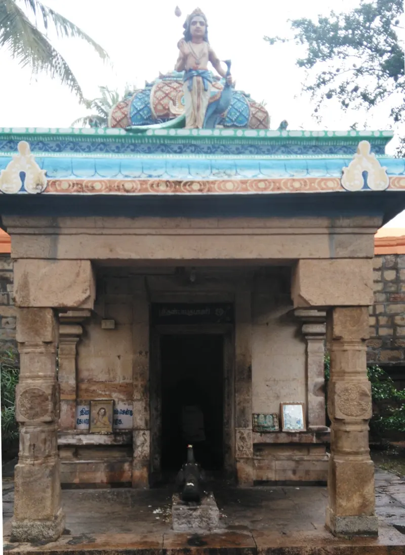 A small stone shrine with a deity figure above the entrance