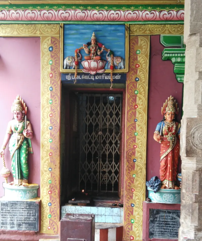 Gated shrine door with goddess statues on both sides