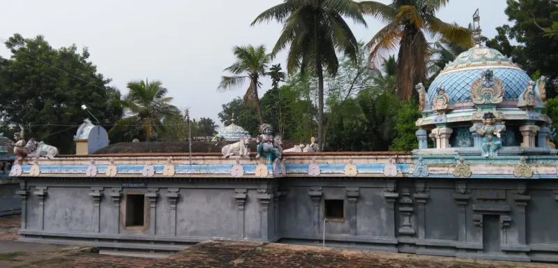 Bull and deity statues along the top of a shrine wall