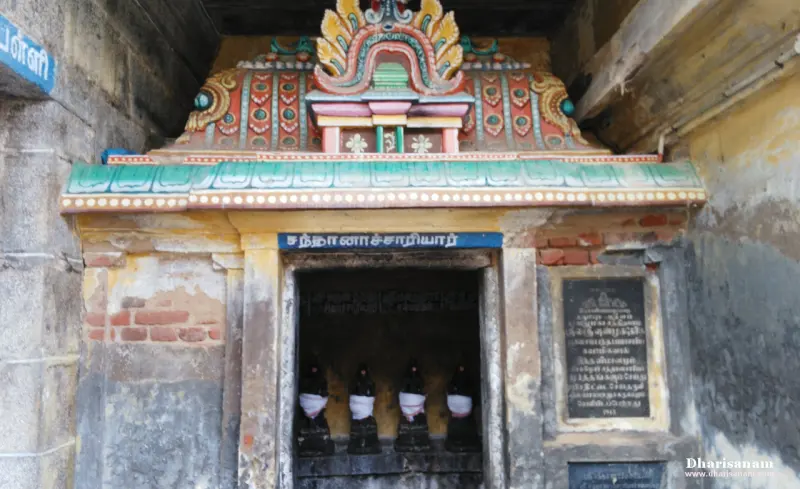 Four draped idols in a small painted shrine