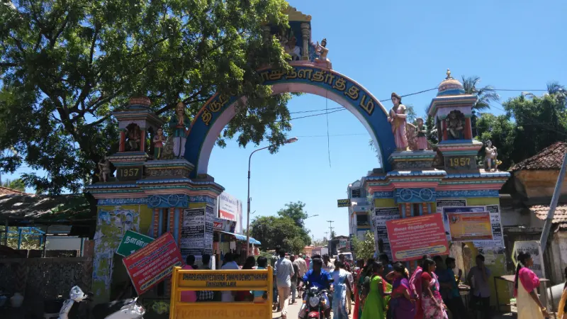 The arched entrance to the temple street, with devotees