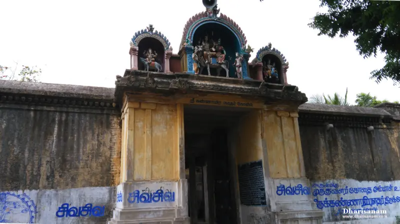 Wide view of the sculpted entrance arch between weathered yellow walls