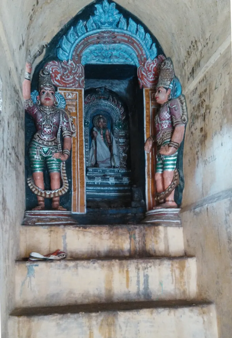 Niche shrine with a deity between two painted guardians