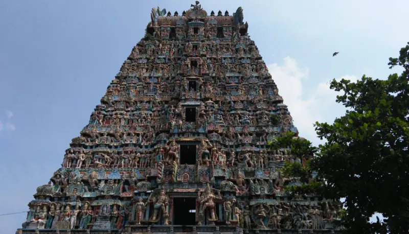 Towering sculpted gopuram covered in painted figures