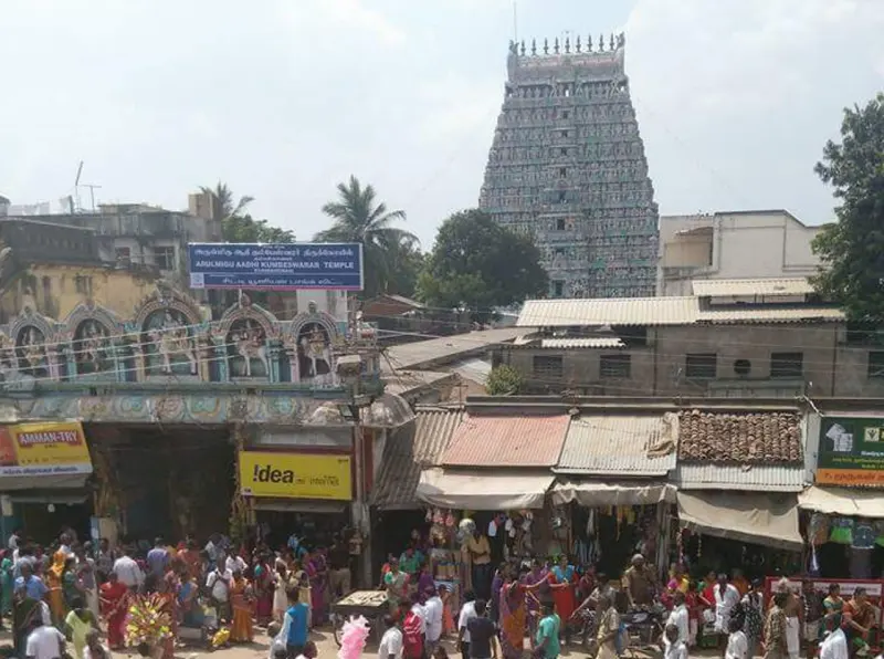Festival crowd in the street with the grey tower beyond