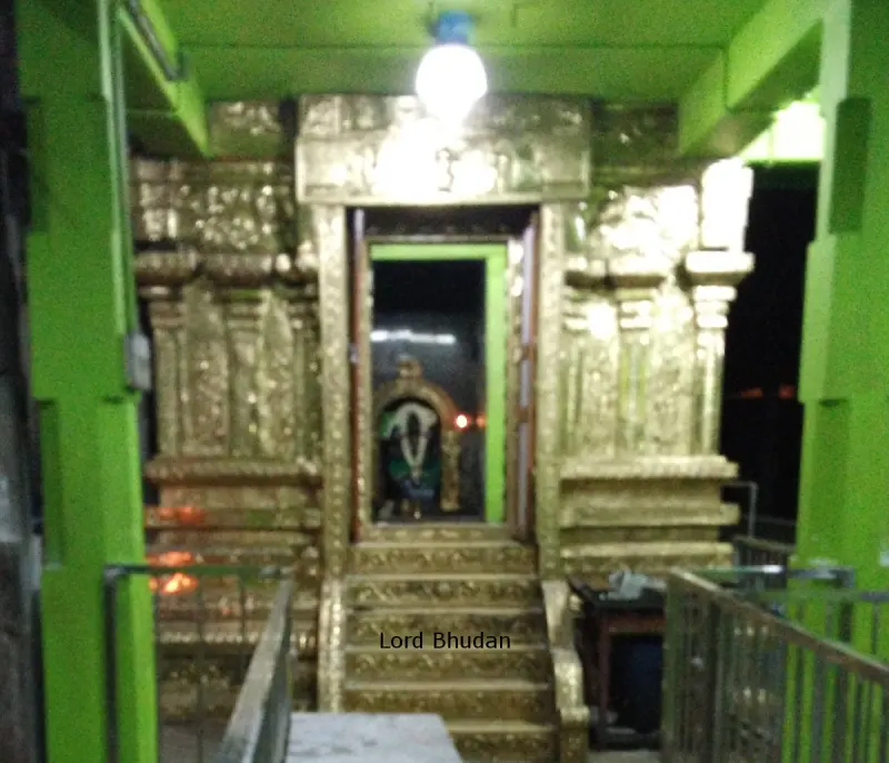 A shrine doorway with golden stone frames and green pillars; the picture is labelled Lord Bhudan