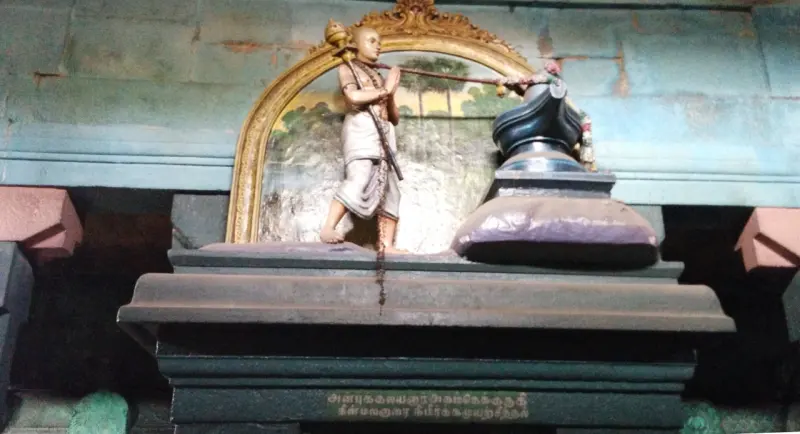 Painted saint pulling a rope tied round a lingam