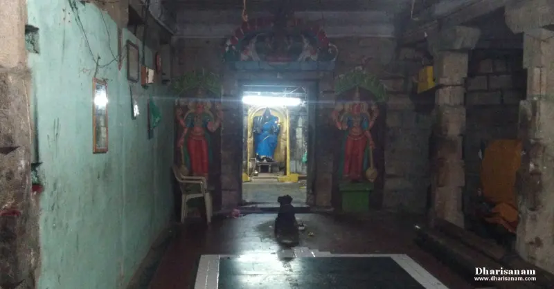 Doorway with red guardian figures on both sides, blue idol inside