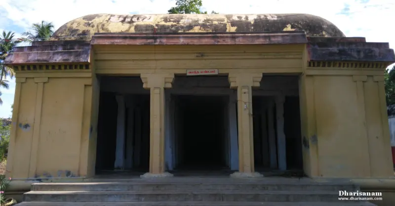 A yellow-walled hall with a pillared front porch and a low domed roof, three steps leading up